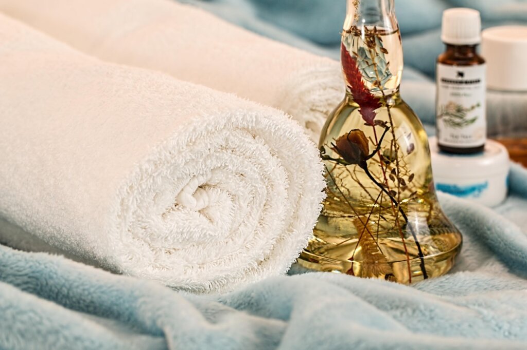 small amber glass spray bottles with essential oil and dropper on bathroom counter