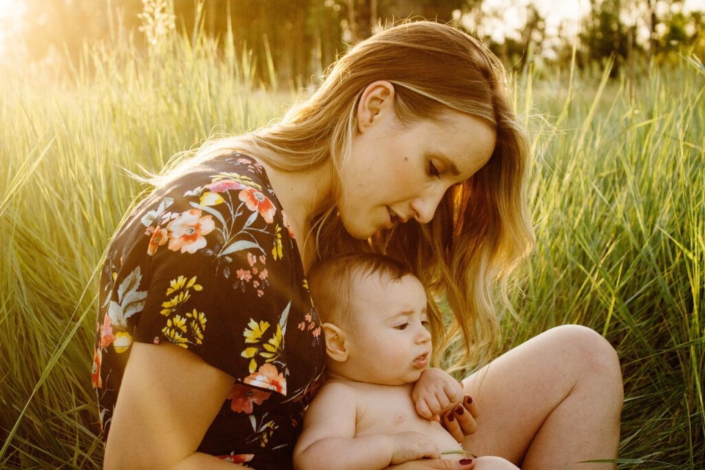mother and child sitting comfortably in a cool clean room with air conditioner running