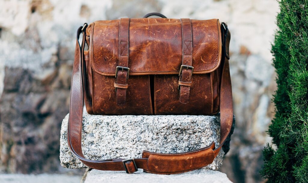 mesh bag filled with coffee grounds placed inside leather dress shoes