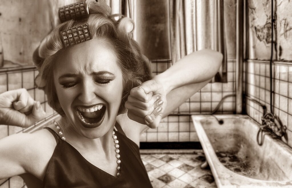 citric acid powder and hair conditioner on bathroom shelf