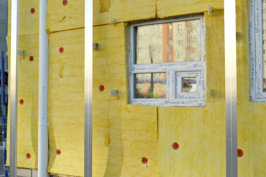 thermal insulation foam being applied to interior concrete wall
