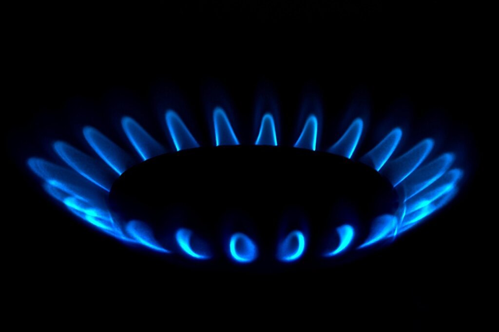 gas stove igniter electrode close-up with dry brush cleaning