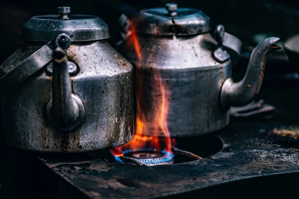 reassembled clean gas stove with shiny burner parts in a bright kitchen