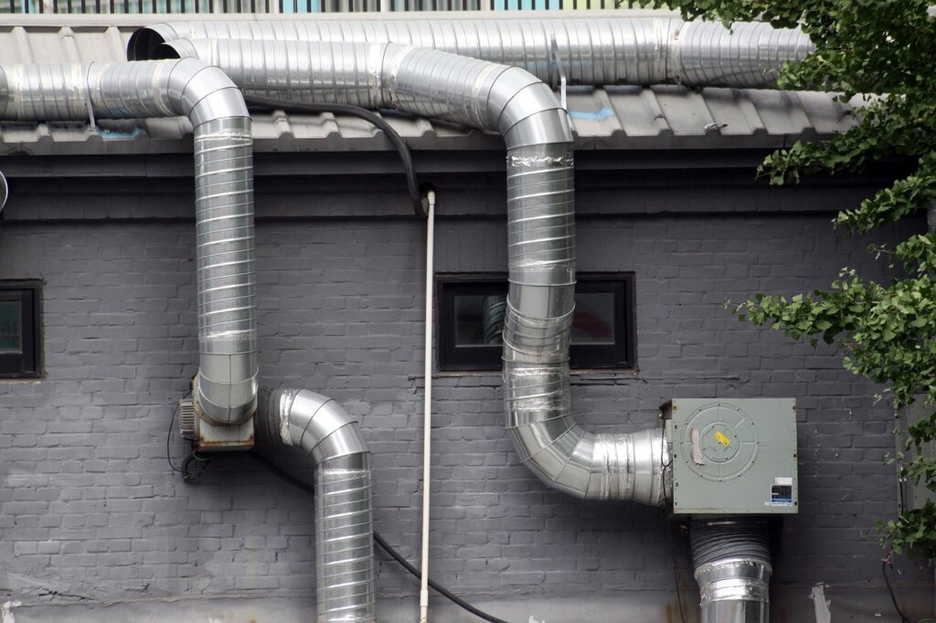 bathroom exhaust fan vent grille covered in gray dust and lint