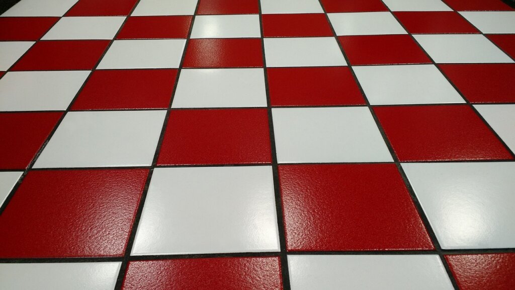 applying white grout pen on kitchen tile grout lines
