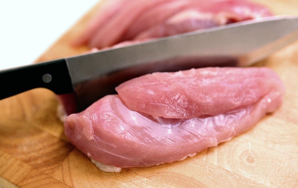 raw meat and fish in bottom refrigerator drawer sealed container
