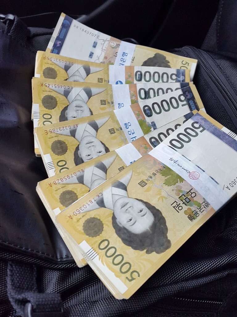 Korean won banknotes and monthly calendar on wooden table