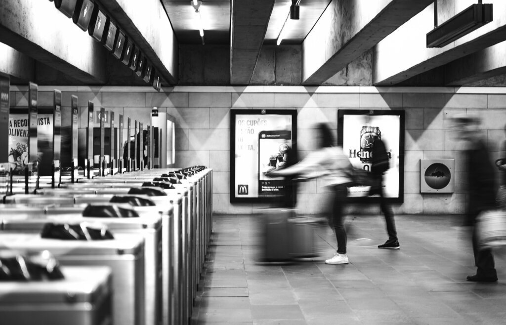 pregnant woman tapping transportation card at subway turnstile