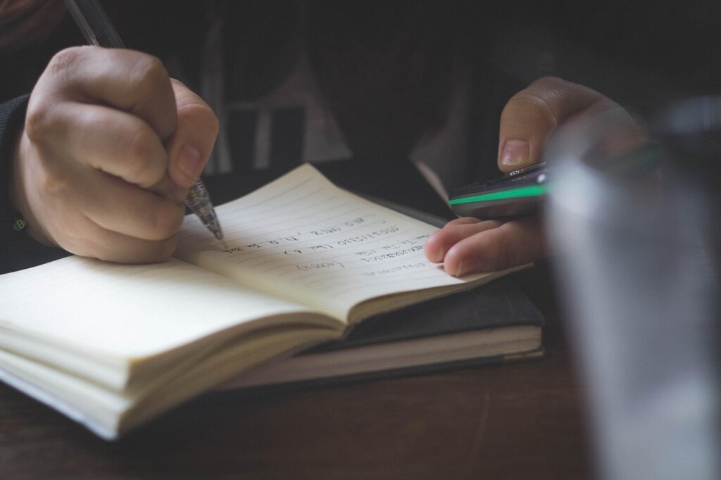 young student reviewing welfare application documents at home