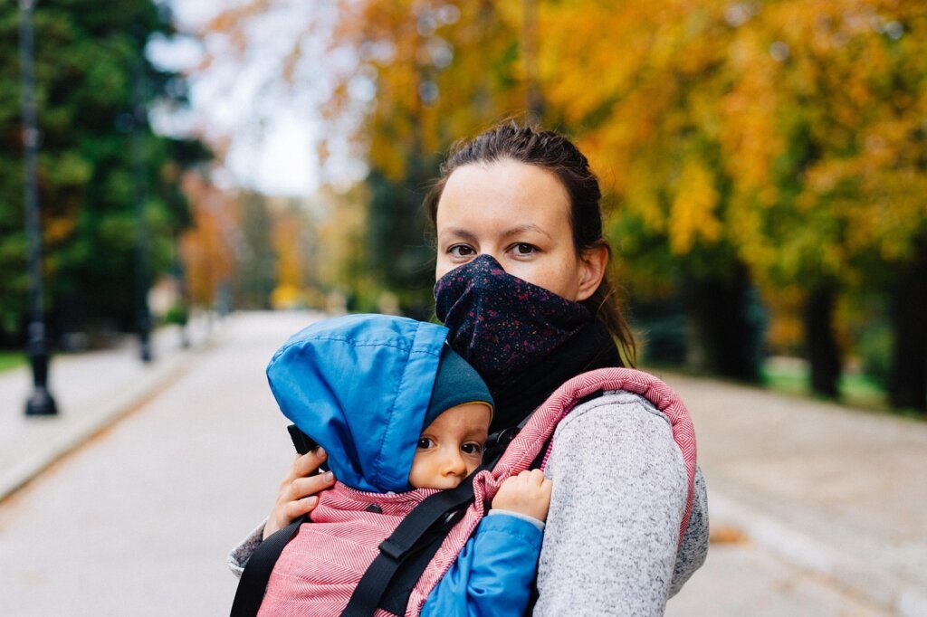 health care worker helping new mother with baby care at home