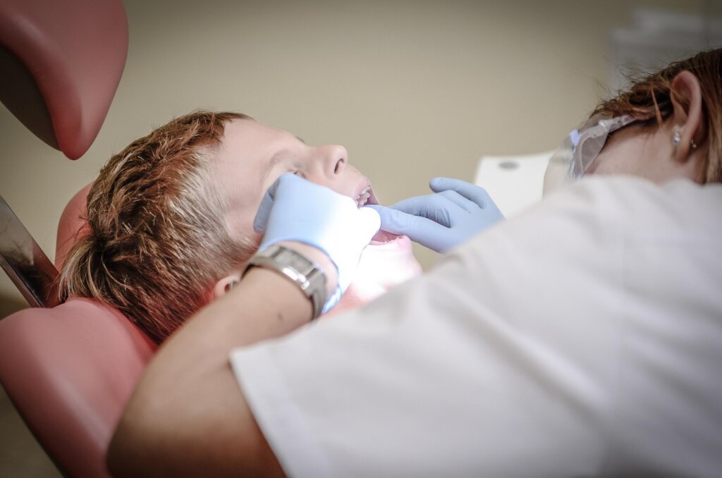 elderly woman checking dental x-ray with dentist