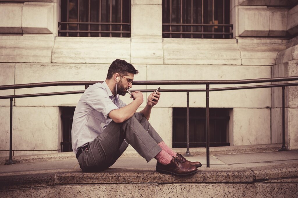 senior man looking at smartphone checking insurance website