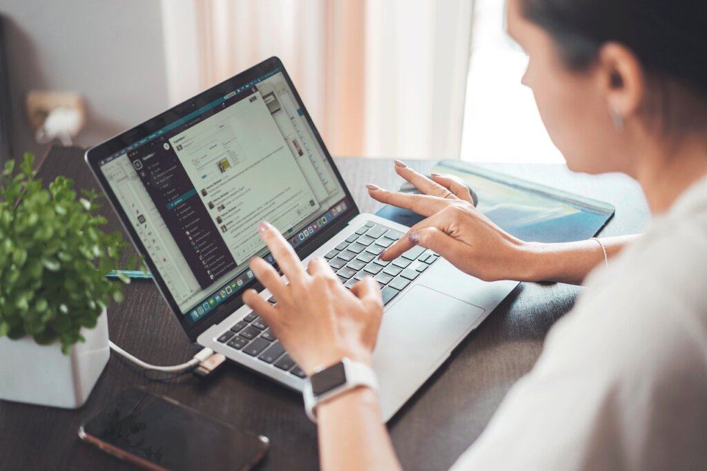 woman filling out online application form on laptop