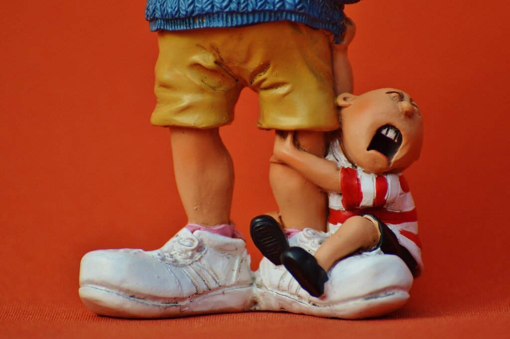 childcare worker playing with toddler at home