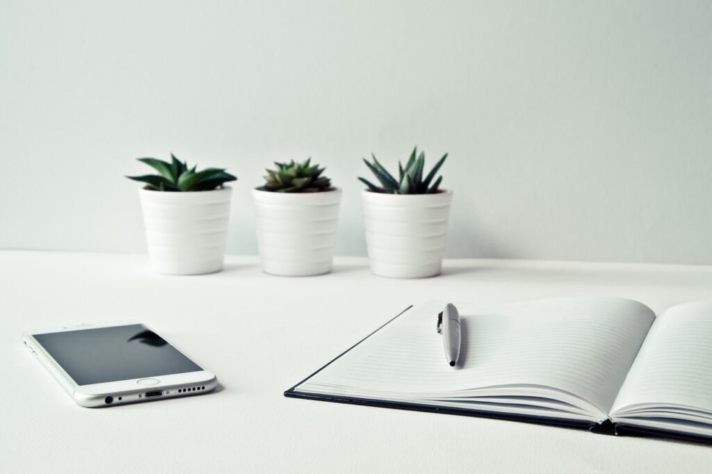 neatly organized loan application documents on white desk with pen and clipboard