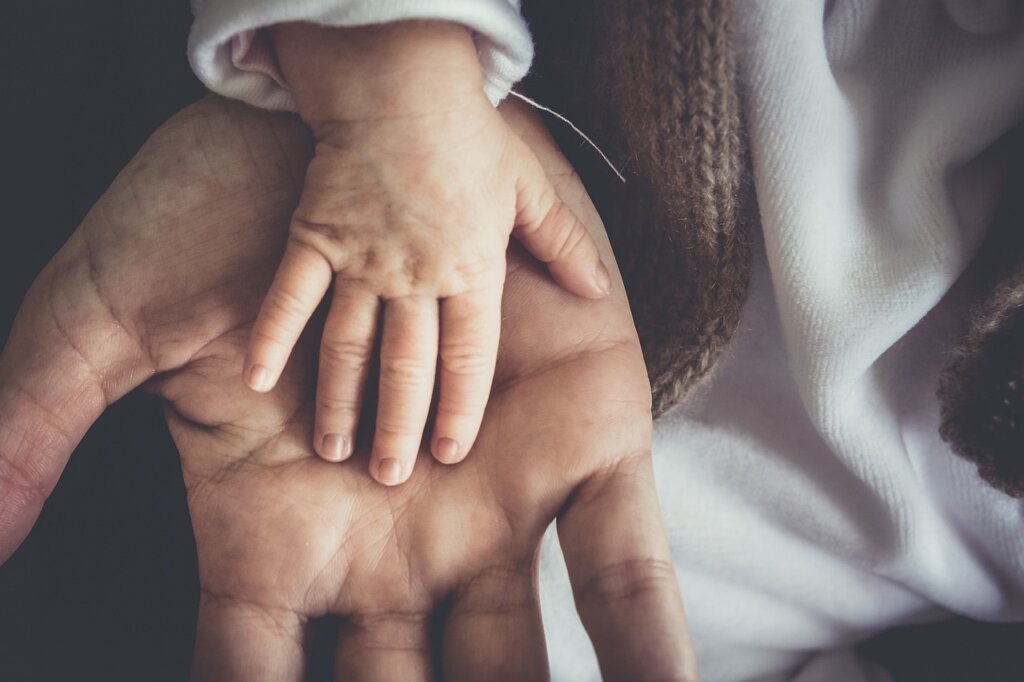 adult child helping elderly parent fill out welfare card application form
