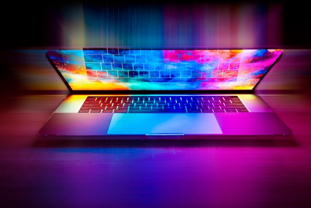 person checking eligibility criteria on laptop screen with a notebook open beside it
