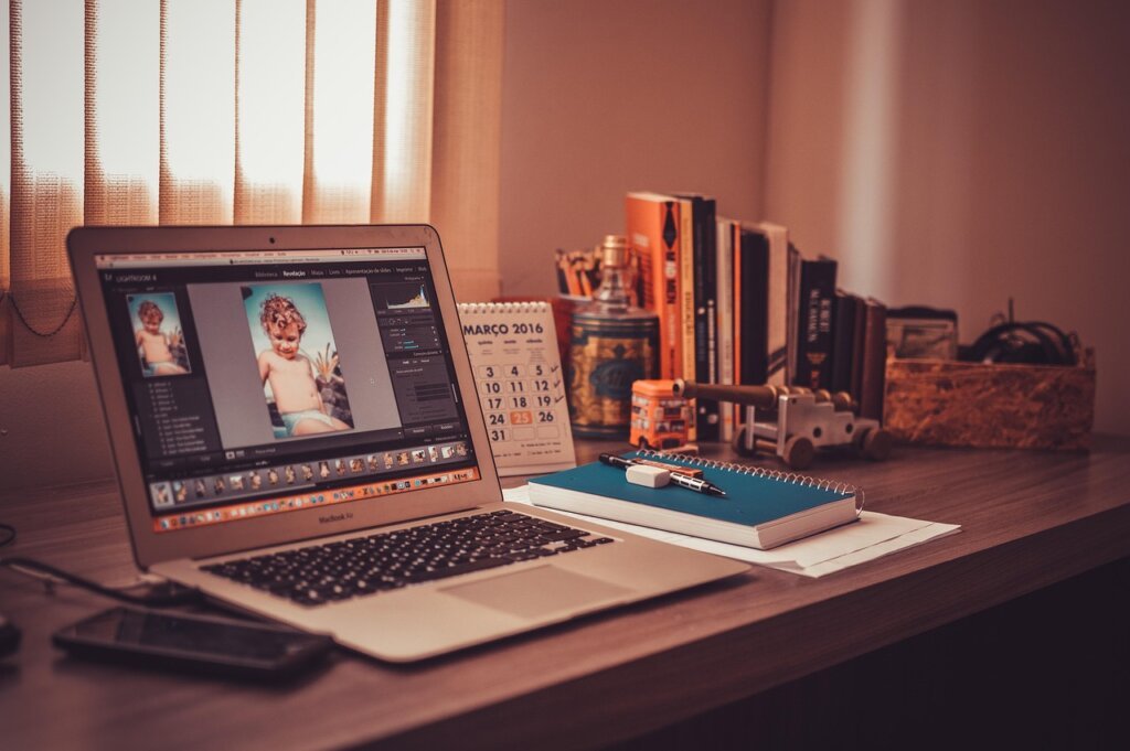 freelance designer at studio desk comparing insurance payment options