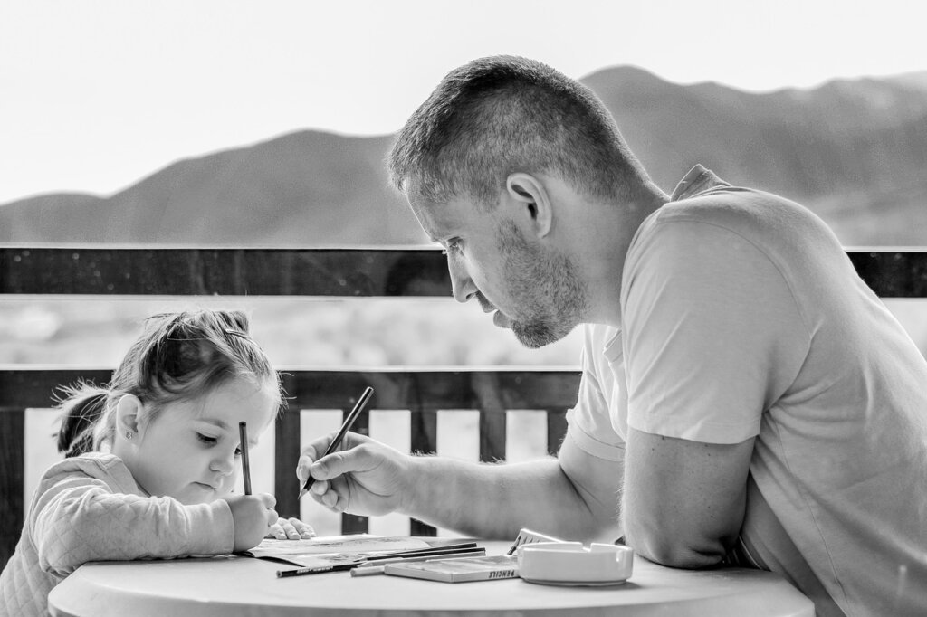 korean parent filling out education support application form at desk