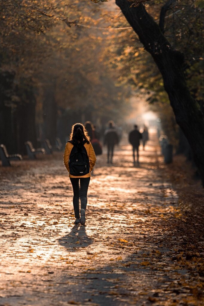 elderly Korean couple walking happily in neighborhood after work, golden hour light