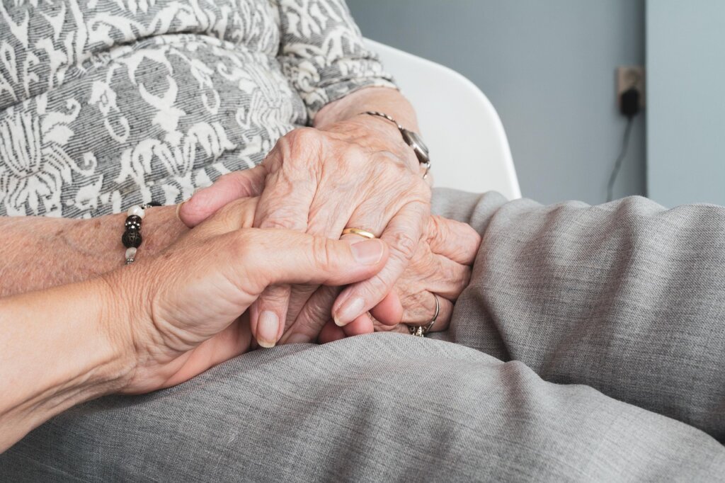 Korean senior woman working as elderly care assistant home visit