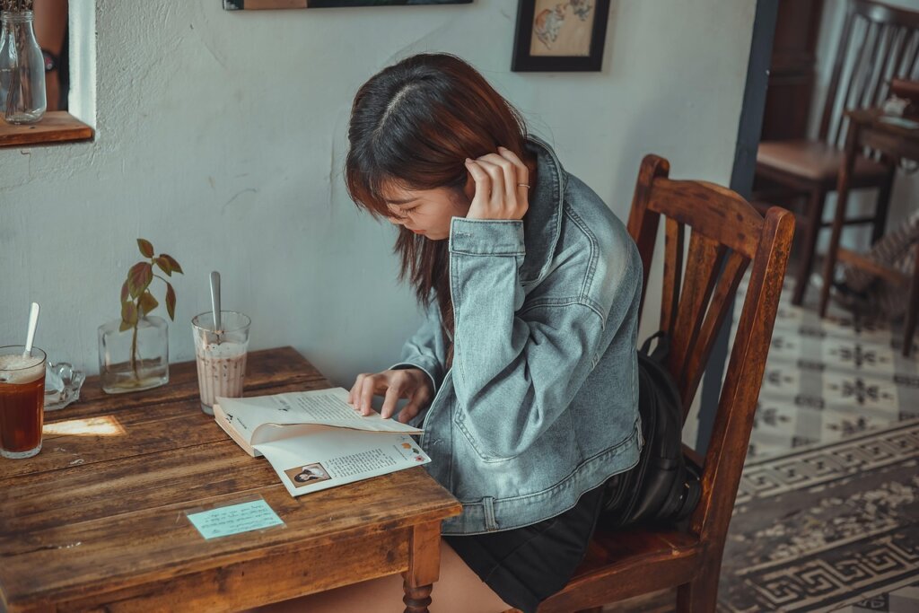 woman reading government support document at table